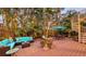Inviting backyard featuring stylish patio furniture, lush tropical plants, and string lights for evening relaxation at 4941 Commonwealth Dr, Sarasota, FL 34242