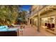 Tranquil backyard with a comfortable outdoor seating area, spiral staircase to the second floor, and string lights at 4941 Commonwealth Dr, Sarasota, FL 34242
