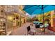 Outdoor patio with spiral staircase, dining area, and comfortable seating, surrounded by tropical greenery at 4941 Commonwealth Dr, Sarasota, FL 34242