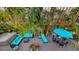 Outdoor lounge area with string lights, modern furnishings, lush landscaping and hot tub at 4941 Commonwealth Dr, Sarasota, FL 34242