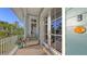 Cozy balcony with seating and a view of lush greenery at 4941 Commonwealth Dr, Sarasota, FL 34242