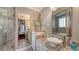 Well-lit bathroom featuring granite counters, with a view into bedroom at 4941 Commonwealth Dr, Sarasota, FL 34242