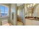 Beautiful bathroom featuring tile shower, granite counters, and a large window at 4941 Commonwealth Dr, Sarasota, FL 34242