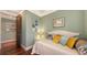 Inviting bedroom featuring calming decor, a cozy bed, and hardwood floors at 4941 Commonwealth Dr, Sarasota, FL 34242