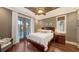 Cozy bedroom featuring hardwood floors and a private balcony at 4941 Commonwealth Dr, Sarasota, FL 34242