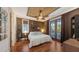 Comfortable bedroom with hardwood floors, bamboo ceiling, and access to a balcony at 4941 Commonwealth Dr, Sarasota, FL 34242