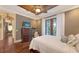 Inviting bedroom showcasing hardwood floors and balcony access at 4941 Commonwealth Dr, Sarasota, FL 34242