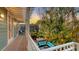 Charming outdoor deck with lush greenery, seating, and an enclosed porch with tropical vibes at 4941 Commonwealth Dr, Sarasota, FL 34242