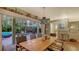 Comfortable dining room with a large wooden table, seating for six, and a view of the outdoor patio at 4941 Commonwealth Dr, Sarasota, FL 34242