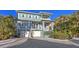 Charming blue two-story home with a brick driveway and white trim at 4941 Commonwealth Dr, Sarasota, FL 34242