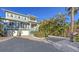 Beautiful two-story home with lush landscaping and brick driveway at 4941 Commonwealth Dr, Sarasota, FL 34242