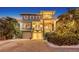 Elegant multi-story home with balconies, lush landscaping, brick driveway, and a two-car garage at 4941 Commonwealth Dr, Sarasota, FL 34242