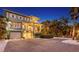 Charming multi-story home with balconies, lush landscaping, brick driveway, and a two-car garage at 4941 Commonwealth Dr, Sarasota, FL 34242