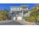 Charming blue two-story home with a brick driveway and white trim at 4941 Commonwealth Dr, Sarasota, FL 34242