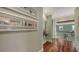 Upper hallway with hardwood floors, artwork, and a view of the staircase at 4941 Commonwealth Dr, Sarasota, FL 34242