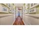 Hallway has picture frame molding, hardwood flooring and a ceiling fan at 4941 Commonwealth Dr, Sarasota, FL 34242