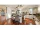 Well-appointed kitchen featuring stainless steel appliances, a wine cooler, and a large granite island with seating at 4941 Commonwealth Dr, Sarasota, FL 34242