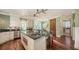 Gourmet kitchen with stainless steel appliances, granite countertops, an island, and a wine cooler at 4941 Commonwealth Dr, Sarasota, FL 34242