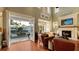 Beautiful living room featuring a fireplace, an exterior balcony, and lots of natural light at 4941 Commonwealth Dr, Sarasota, FL 34242