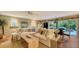 Inviting living room with a large sectional sofa, wood floors, ceiling fan, and access to the outdoor patio at 4941 Commonwealth Dr, Sarasota, FL 34242
