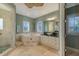 A luxurious bathroom featuring a jacuzzi tub, a separate shower, and dual vanities at 4941 Commonwealth Dr, Sarasota, FL 34242