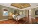 A main bedroom featuring a four-poster bed with wooden floors and a small built-in fireplace and shelving area at 4941 Commonwealth Dr, Sarasota, FL 34242