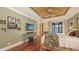 A main bedroom featuring a four-poster bed, wood floors, a television, and french doors to a balcony at 4941 Commonwealth Dr, Sarasota, FL 34242