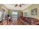 Comfortable office features a desk, leather sofa, hardwood floors, and a balcony with a view at 4941 Commonwealth Dr, Sarasota, FL 34242