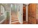 Staircase and elevator with wood accents and natural light create an elegant transition between floors at 4941 Commonwealth Dr, Sarasota, FL 34242