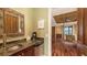 A convenient wet bar with granite counters, a small fridge, and a coffee maker sits adjacent to a bedroom at 4941 Commonwealth Dr, Sarasota, FL 34242