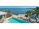 Gorgeous aerial view of the backyard infinity pool, dock, and stunning waterfront scenery at 511 Bayview Dr, Holmes Beach, FL 34217