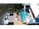 Aerial view of beautiful waterfront home with a pool, spa, and private boat lift at 511 Bayview Dr, Holmes Beach, FL 34217