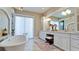 Unwind in this bathroom with a soaking tub and a double vanity at 511 Bayview Dr, Holmes Beach, FL 34217