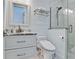 This bathroom features a sleek vanity with a marble countertop and a modern shower at 511 Bayview Dr, Holmes Beach, FL 34217