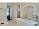 The bathroom features a freestanding tub and a mosaic tile accent wall at 511 Bayview Dr, Holmes Beach, FL 34217