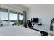 Enjoy water views in this bright bedroom with a work space and sliding doors to a balcony at 511 Bayview Dr, Holmes Beach, FL 34217