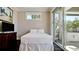 Bright bedroom with a queen bed and sliding glass doors to a private balcony at 511 Bayview Dr, Holmes Beach, FL 34217