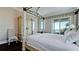 Relax in this spacious main bedroom with views of the water from the balcony at 511 Bayview Dr, Holmes Beach, FL 34217