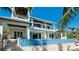 Impressive home featuring an infinity pool, balconies, and outdoor living spaces overlooking the water at 511 Bayview Dr, Holmes Beach, FL 34217