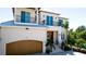 Stunning home with a front entry featuring a wood door, balconies, and a spacious garage at 511 Bayview Dr, Holmes Beach, FL 34217