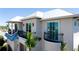 An elegant exterior view of this property featuring balconies and detailed finishes at 511 Bayview Dr, Holmes Beach, FL 34217