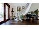 Elegant foyer featuring a grand staircase, hardwood floors, and decorative accents at 511 Bayview Dr, Holmes Beach, FL 34217