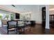 Open-concept kitchen with an island and dark wood floors connected to the dining area at 511 Bayview Dr, Holmes Beach, FL 34217