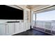 Living room with custom built-ins, waterfront views, and access to the outdoor balcony at 511 Bayview Dr, Holmes Beach, FL 34217