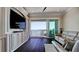 Bright living room features water views, built-in cabinetry, and balcony access at 511 Bayview Dr, Holmes Beach, FL 34217