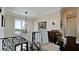 Staircase with wrought iron railing, a chandelier, and a view of the outside at 511 Bayview Dr, Holmes Beach, FL 34217