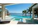 Tranquil infinity pool with breathtaking waterfront views, a spa, and inviting lounge chairs at 511 Bayview Dr, Holmes Beach, FL 34217