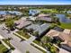 Aerial view of the home showcasing the roof, pool, landscaping, and neighborhood near the golf course at 5270 White Ibis Dr, North Port, FL 34287