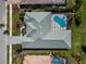 Aerial view of the home showcasing the roof, pool, patio, and landscaping at 5270 White Ibis Dr, North Port, FL 34287