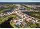 Picturesque aerial shot of a community highlighting lake views, a golf course, and beautiful homes with screened pools at 5270 White Ibis Dr, North Port, FL 34287